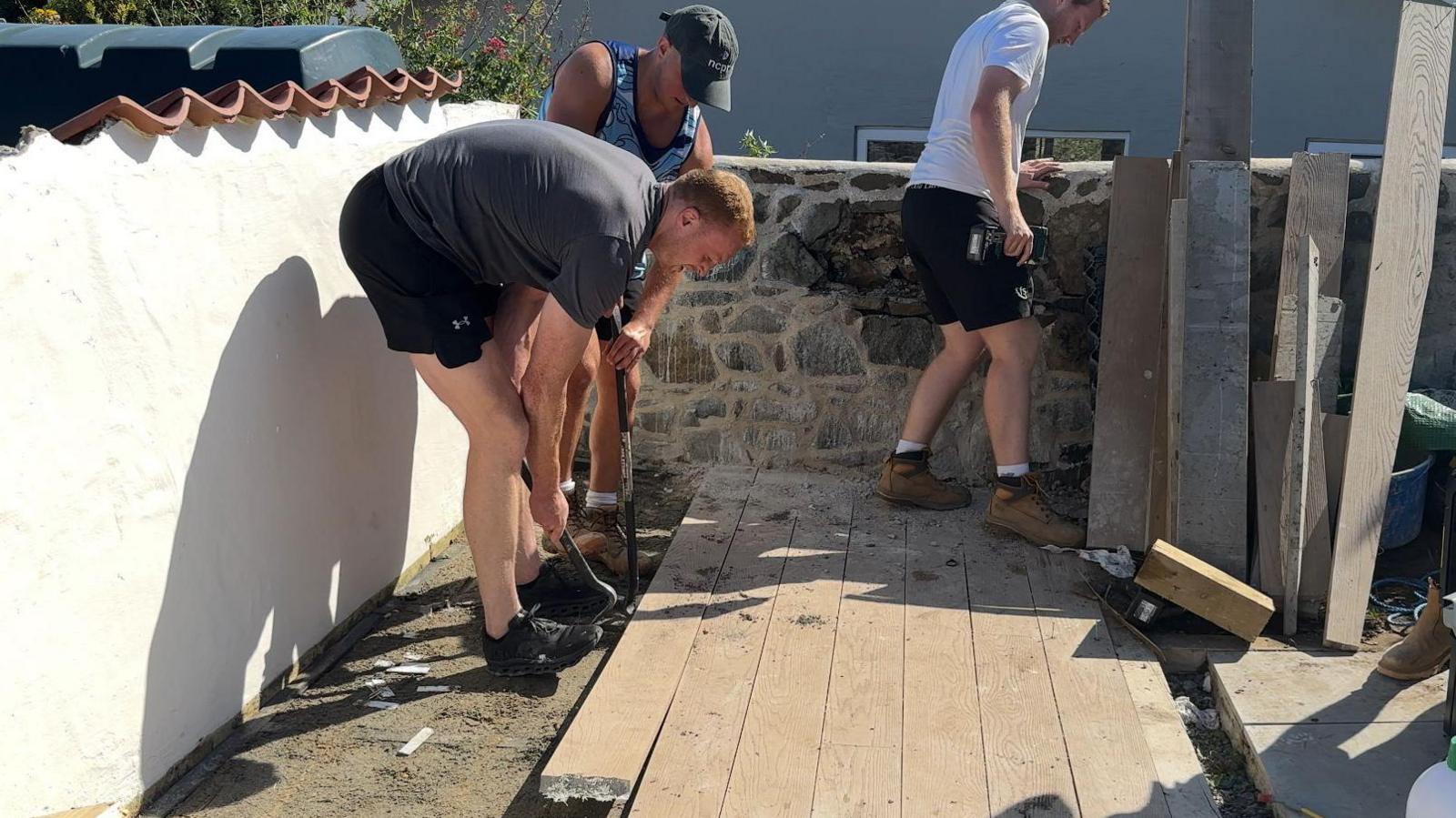 Guernsey Raiders players helping clear the garden