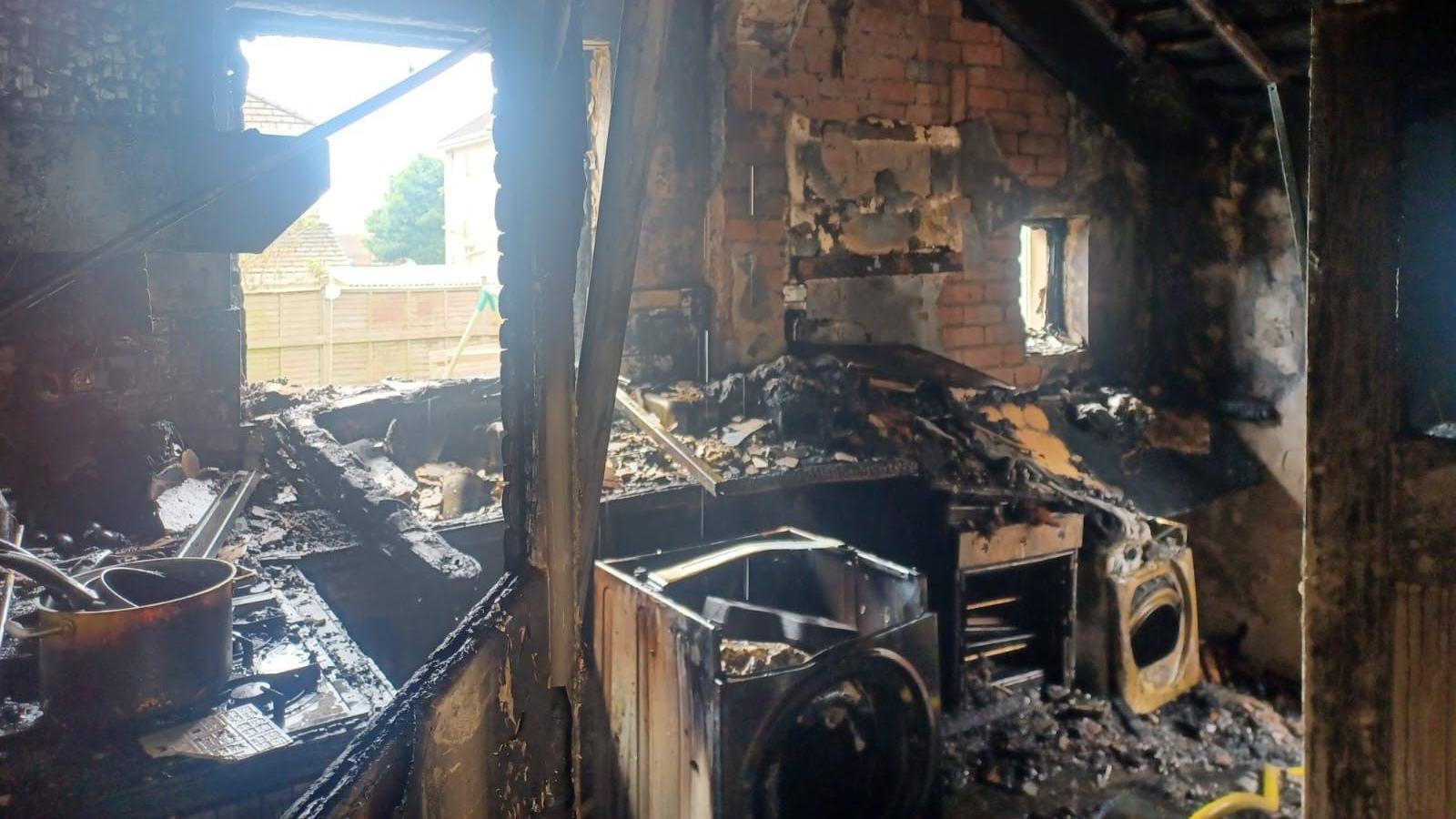 A messy and damaged kitchen caused by fire