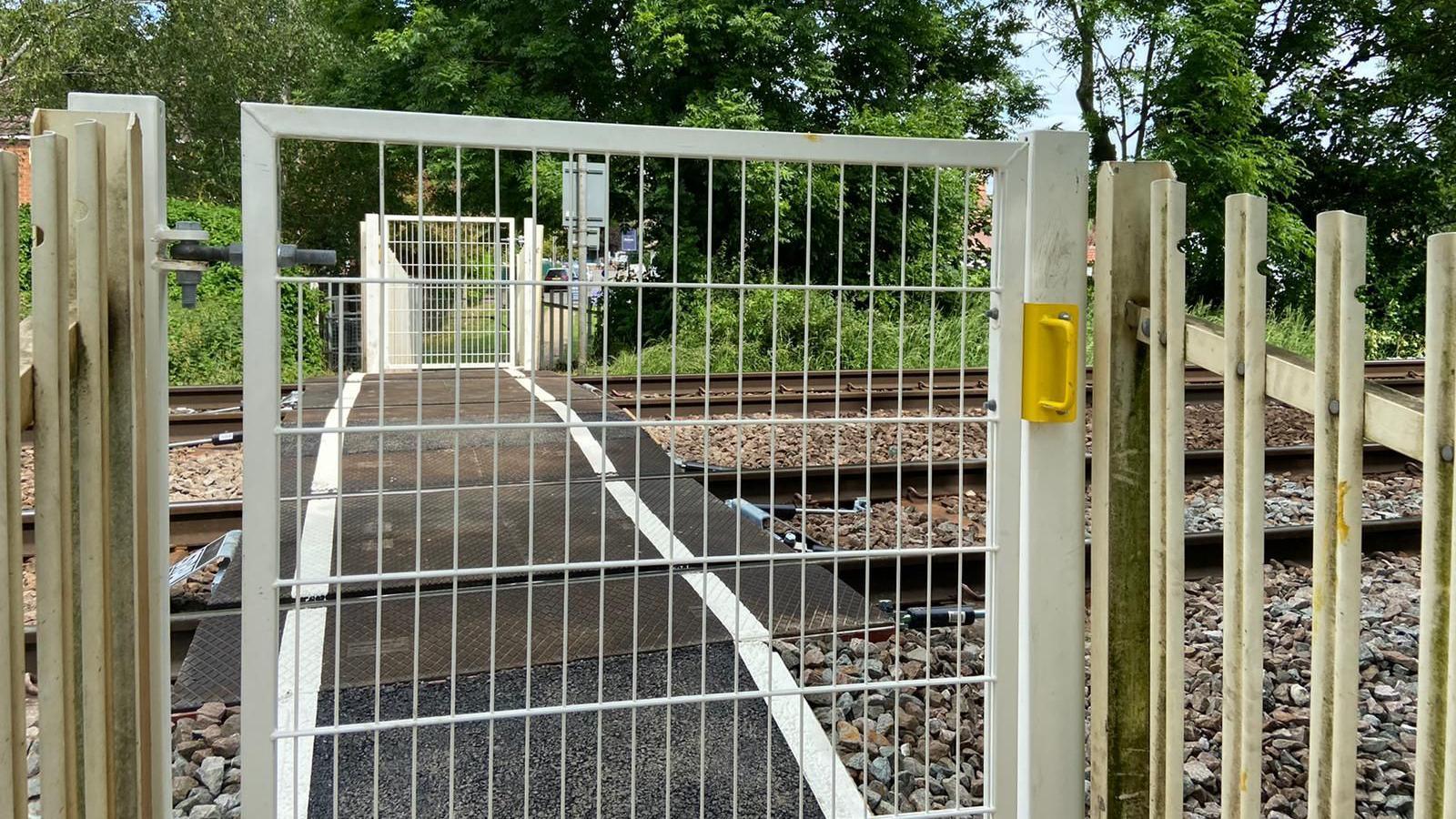 A closed gate in front of a footpath level crossing in Burton Joyce, Nottinghamshire