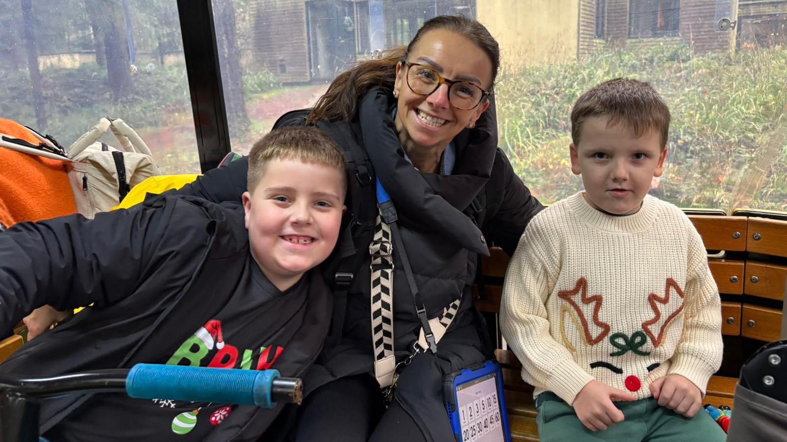 Claire Naylor sat in between sons Jaxon and MJ on a bench