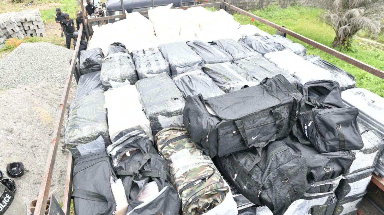 A police lorry is loaded with dozens of black bags and sealed packages in Monrovia