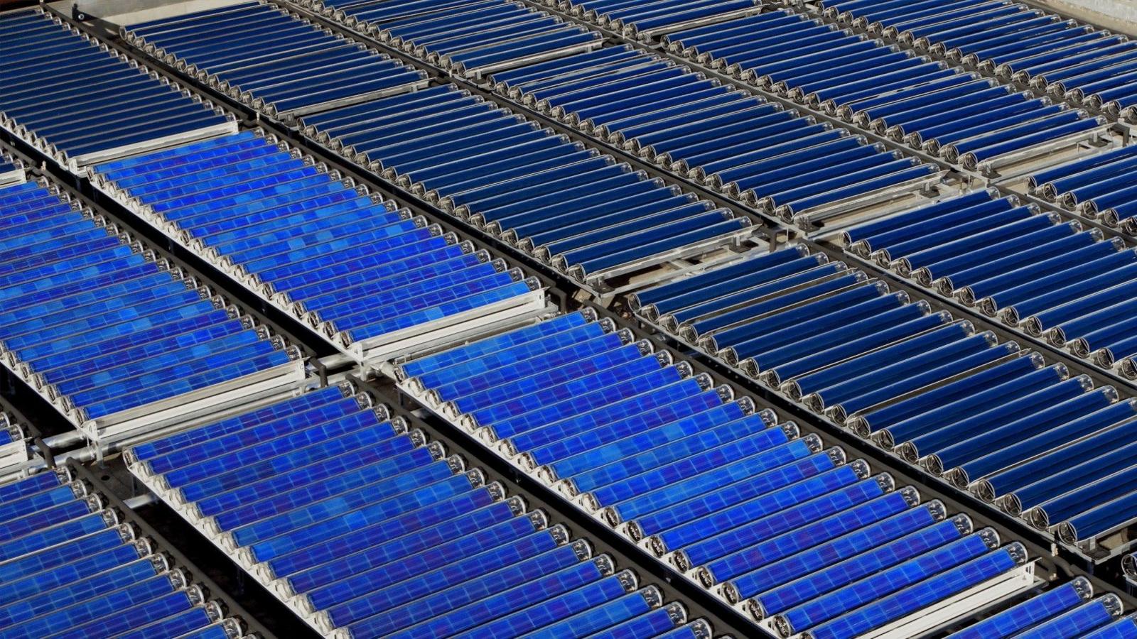 Rows of blue solar collectors on the roof.