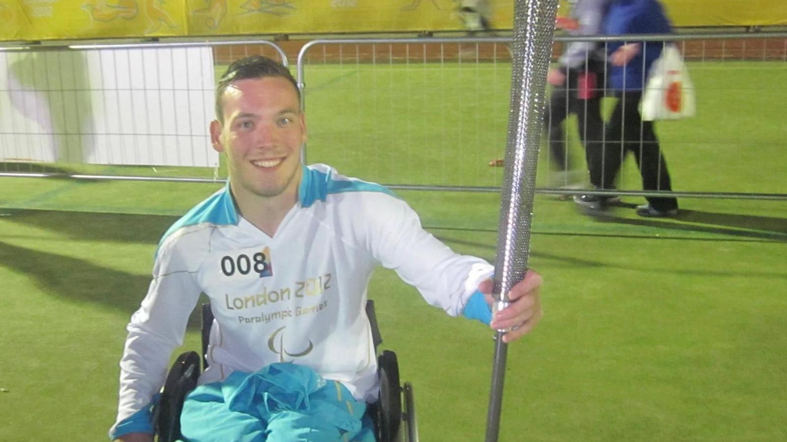 Martin holding the paralympic torch