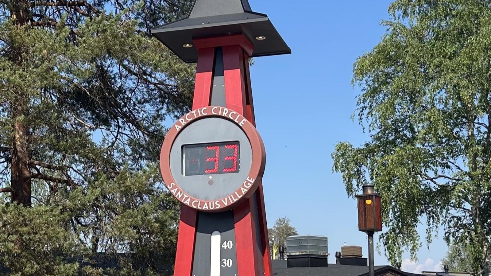 A thermometer outdoors shows the temperature in the Santa Claus village