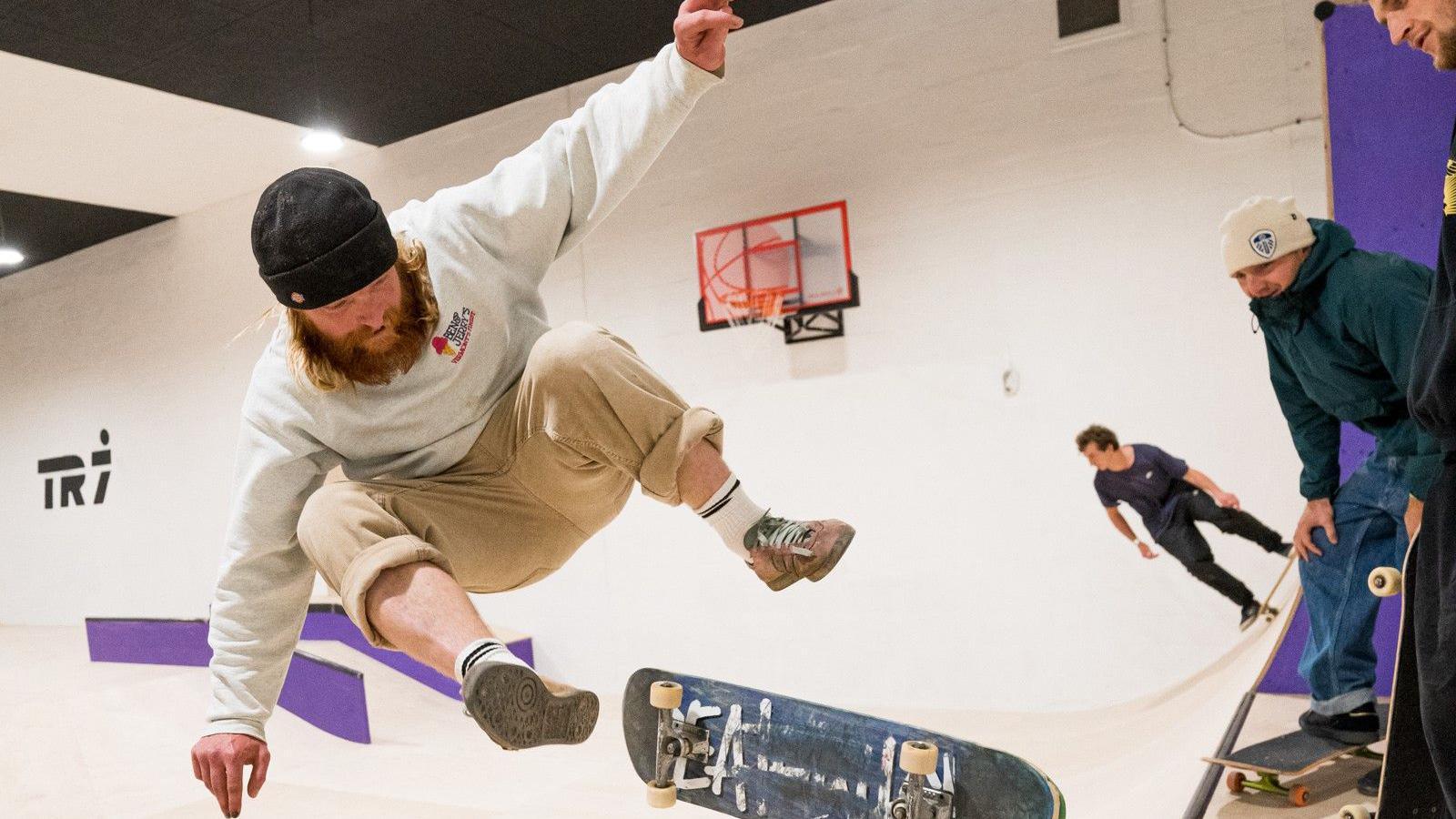 Man jumping off his skateboard as a trick