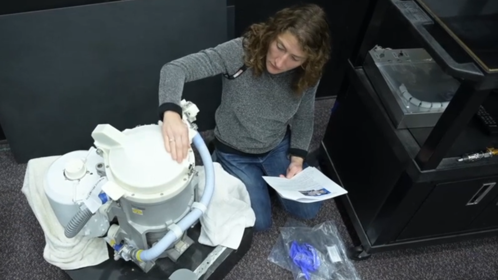 Astronaut Christina Koch with a space toilet