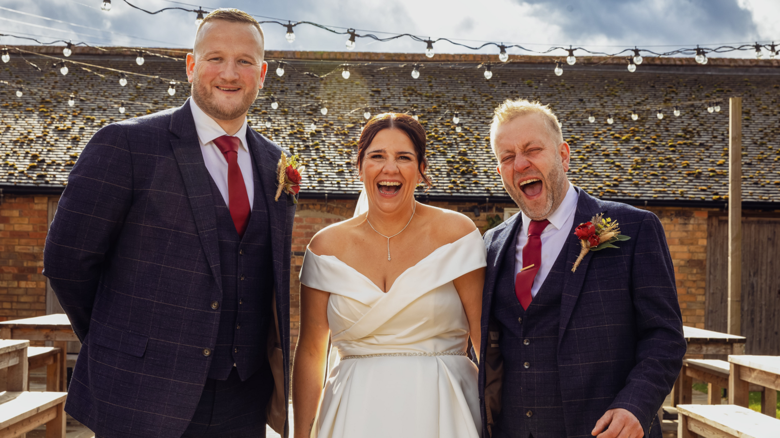 Sam Myring, Martyn Disney and Michelle Disney smile for the camera at the wedding