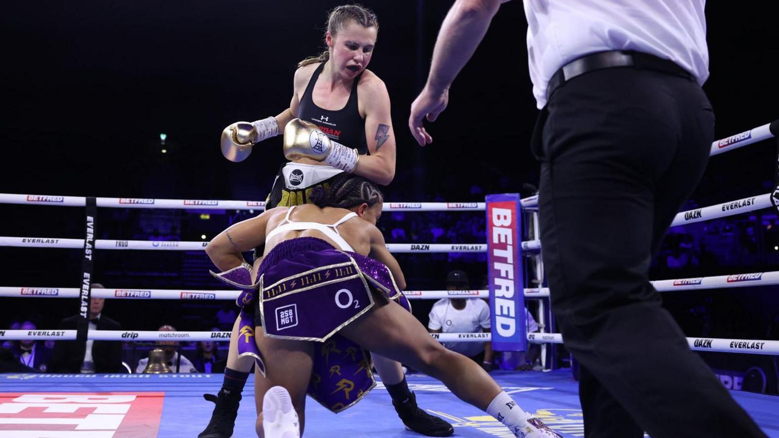 Opponent Shannon Ryan stumbles in front of Emma Dolan in the boxing ring at Birmingham.