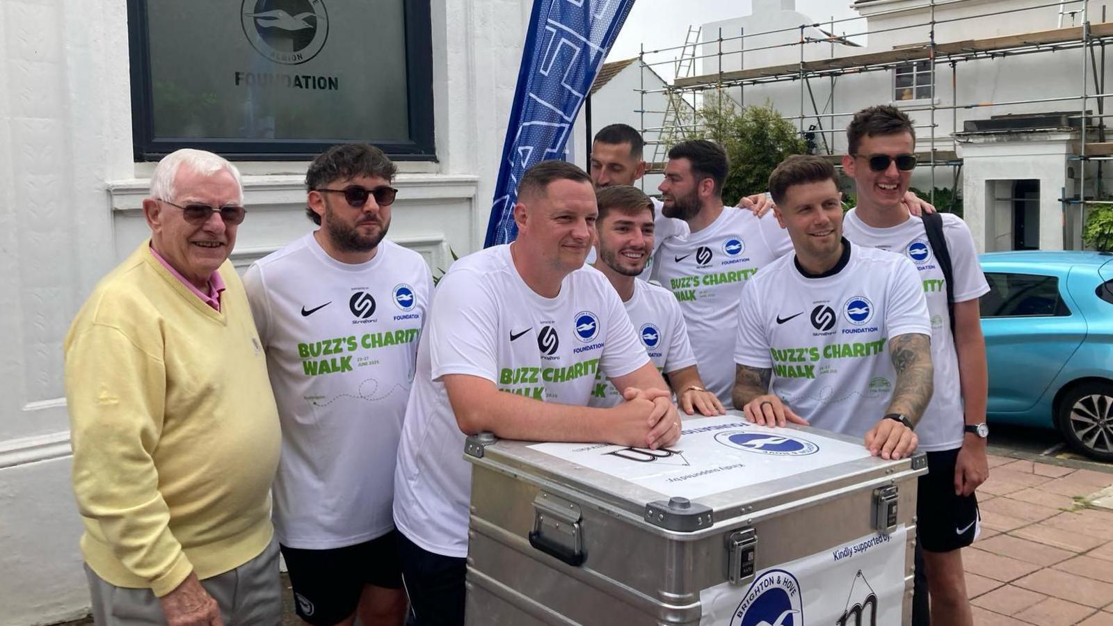 The walking team from Brighton & Hove Albion in football shirts standing outside the foundation HQ on Friday