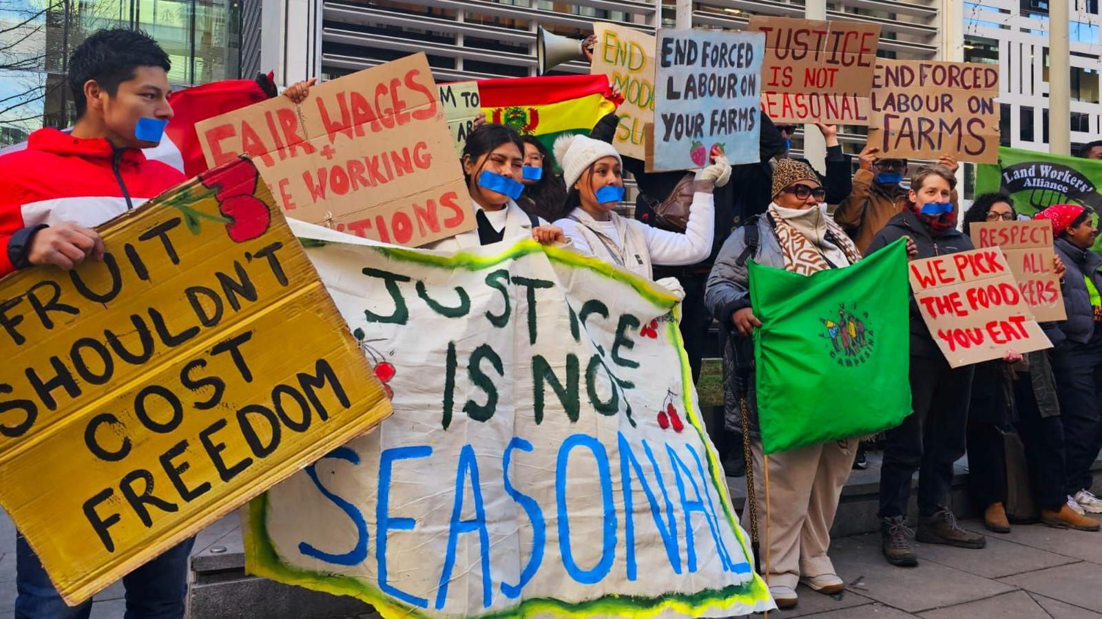 Protesters gathered outside the Home Office holding placards with various slogans such as "Fruit shouldn't cost freedom" and "Justice is not seasonal"