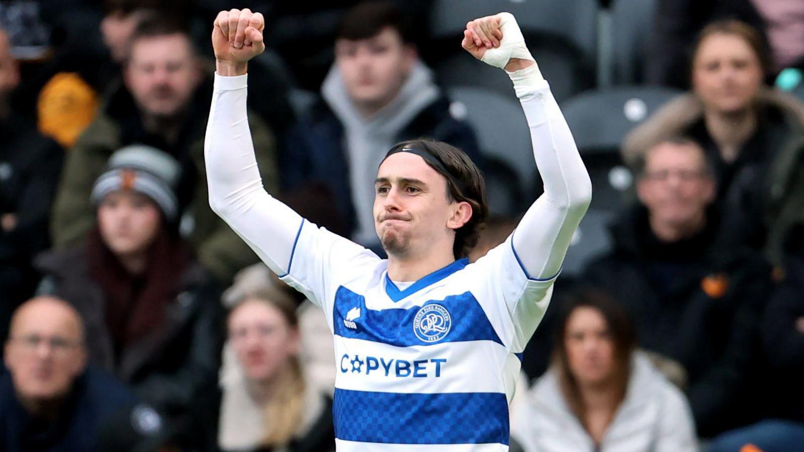 Daniel Bennie celebrates his goal with both arms held aloft