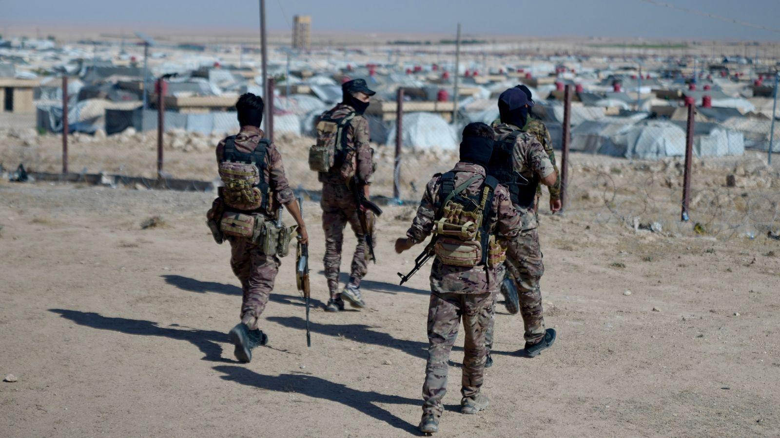 Uniformed Kurdish forces patrolling the area