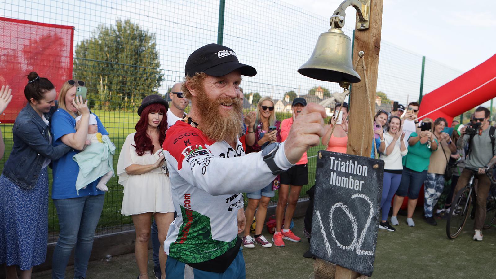 Sean Conway rings finishing bell as community looks on