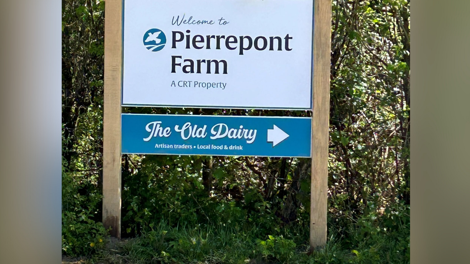 A sign welcoming visitors to Pierrepont Farm in Frensham, Surrey. The sign displays information about the Countryside Regeneration Trust, an organisation dedicted to 'regenerating the countryside and reversing the decline of farmland wildlife'.