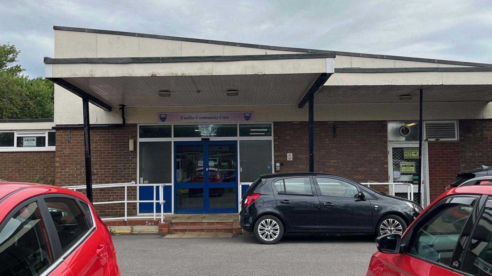 Endike Community Care in north Hull. The building has an angled roof and blue automatic doors. Several cars are parked outside.