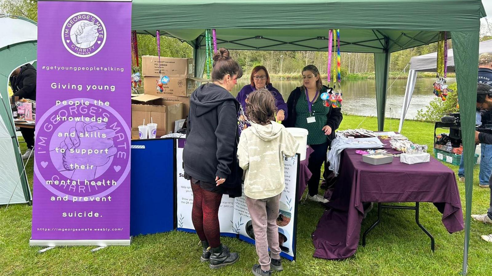 Young people chatting at a stall 