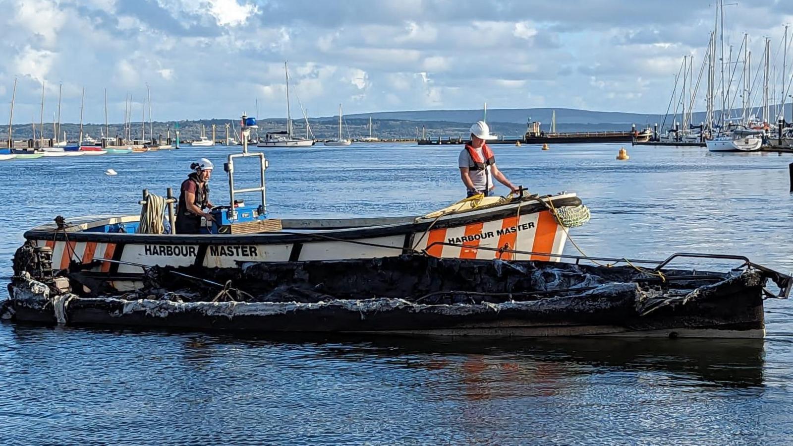 The boat destroyed by the fire.