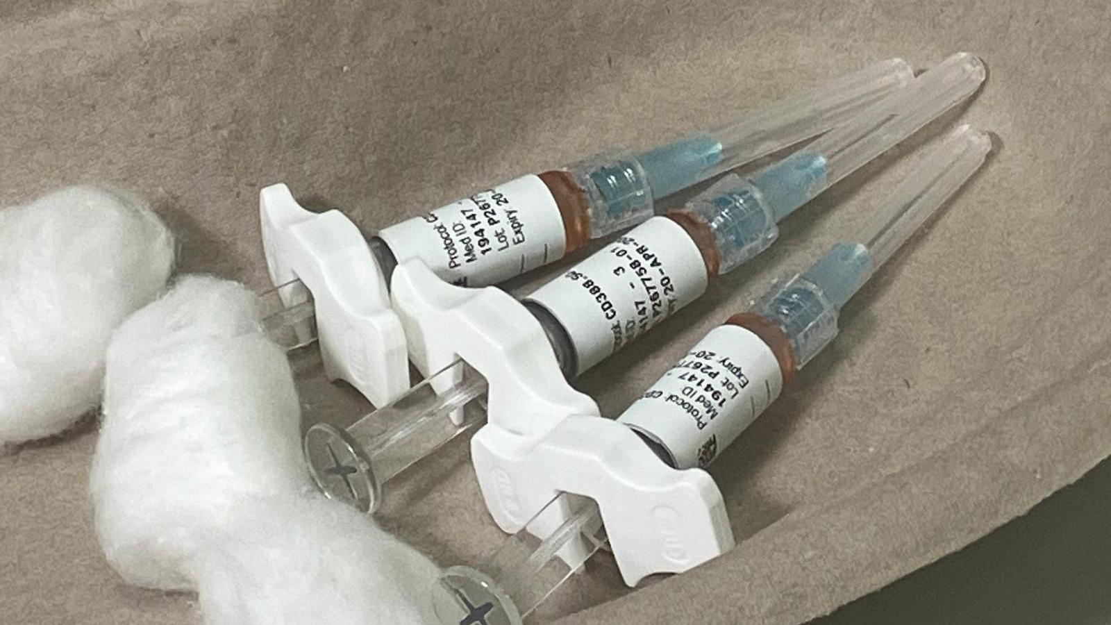 Three hypodermic syringes in a medical dish