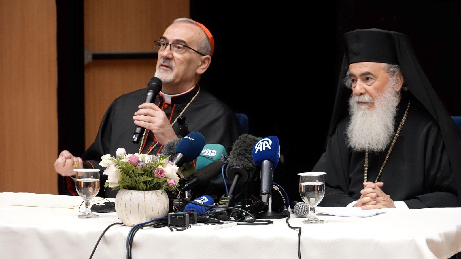 Speaking in front of microphones on top of a white table the Latin Patriarch Cardinal Pierbattista Pizzaballa and Greek Orthodox Patriarch Theophilos III address reporters in Jerusalem on 22 July 2025