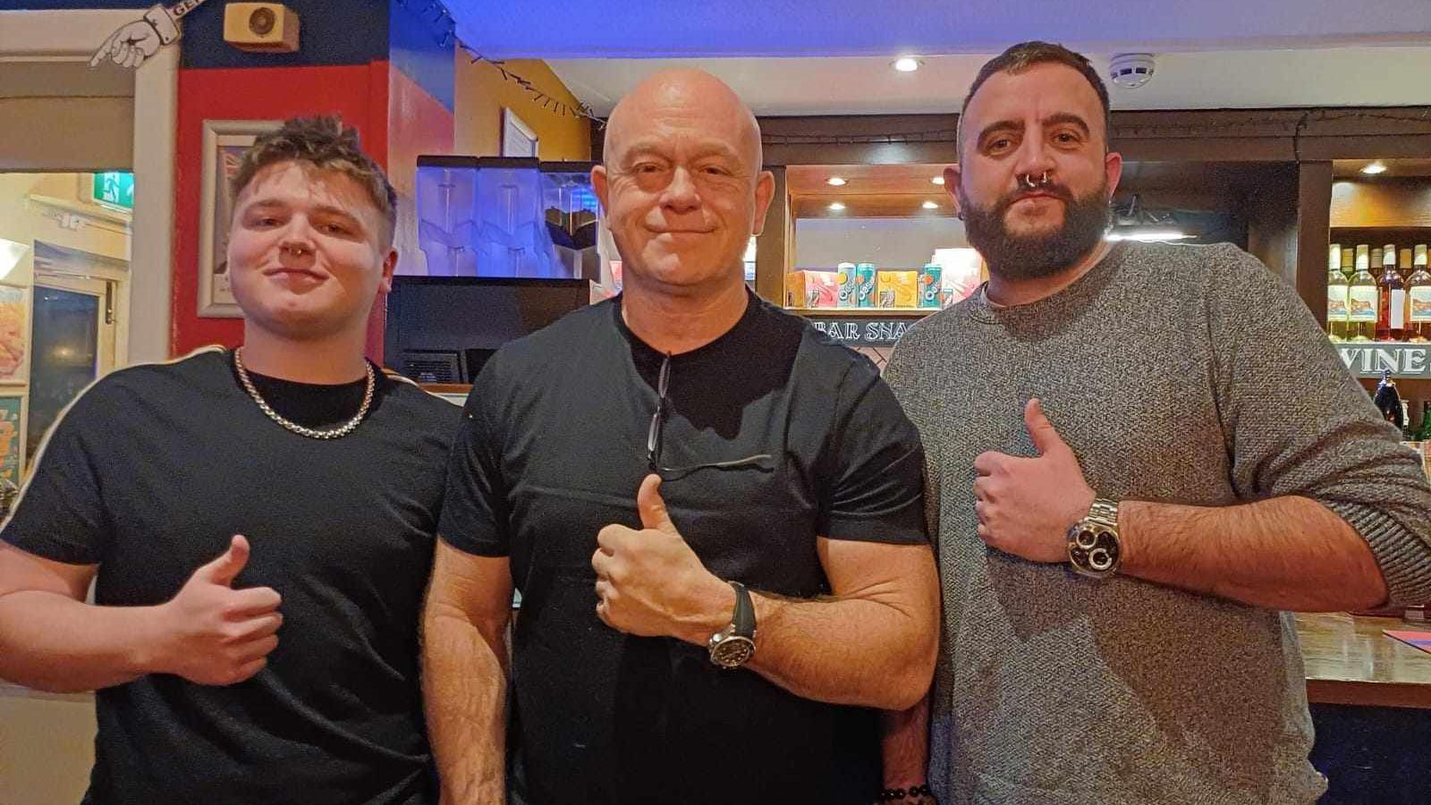 Dan Mason with Ross Kemp and another man. He is wearing a black t shirt.