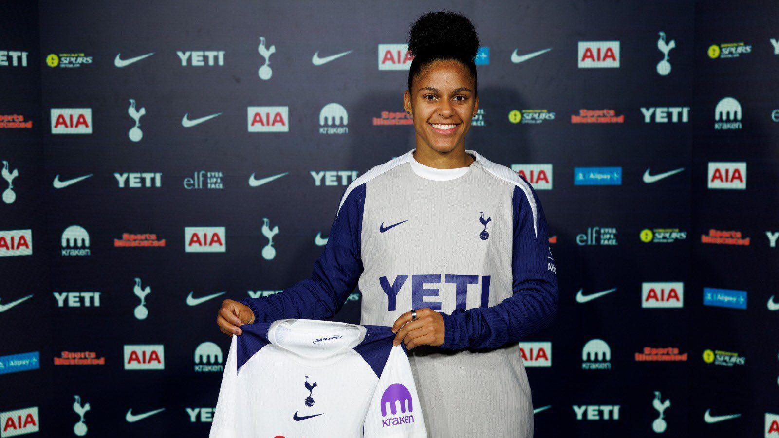 Martinez holding Spurs shirt 