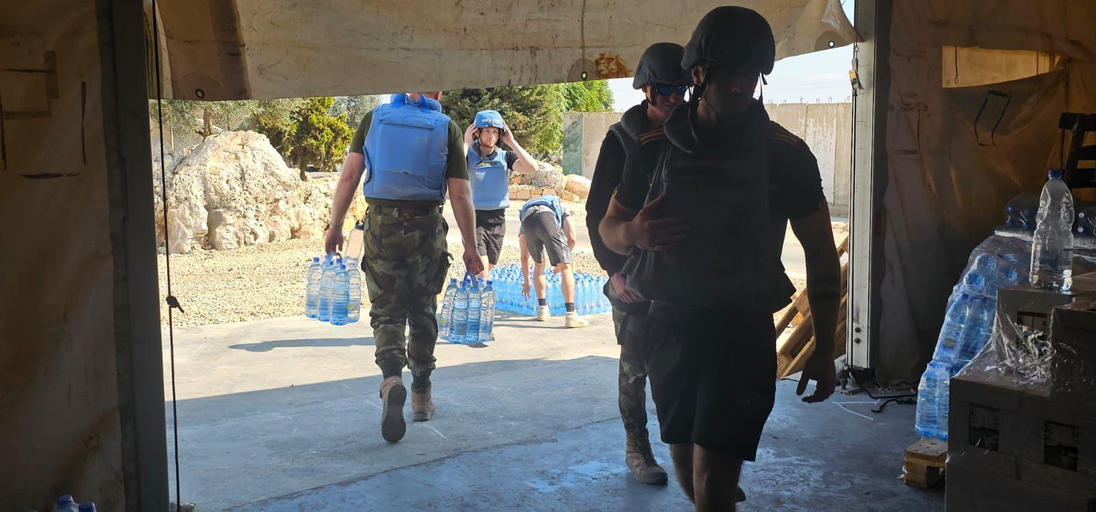 Irish defence force soldiers carrying water into a building in southern Lebanon