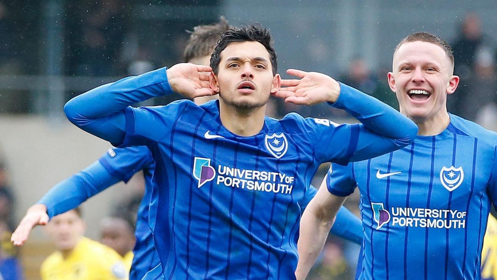 Portsmouth's Andre Dozzell holds his hands to his ears as he celebrates his goal at Oxford United