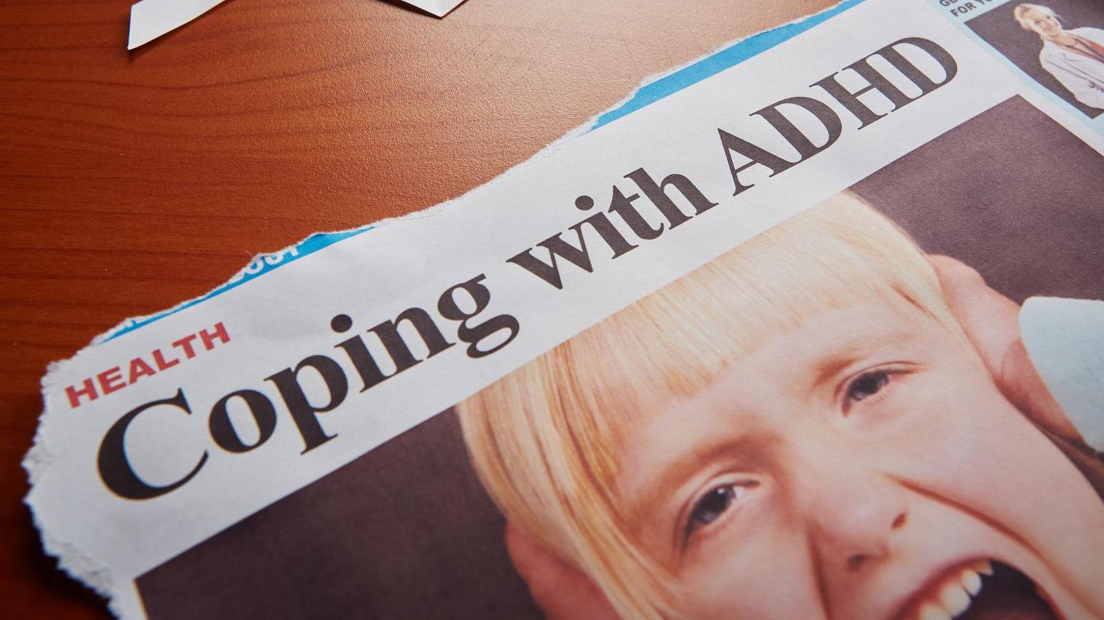 A little girl is seen, hands over ears and yelling furiously, under a newspaper headline reading "Coping with ADHD". The newspaper is a dummy design.