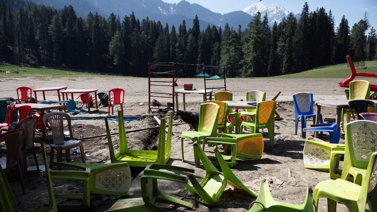 Chairs and tables are scattered at the site of a suspected militant attack on tourists in Baisaran near Pahalgam in south Kashmir's Anantnag district, April 24, 2025.