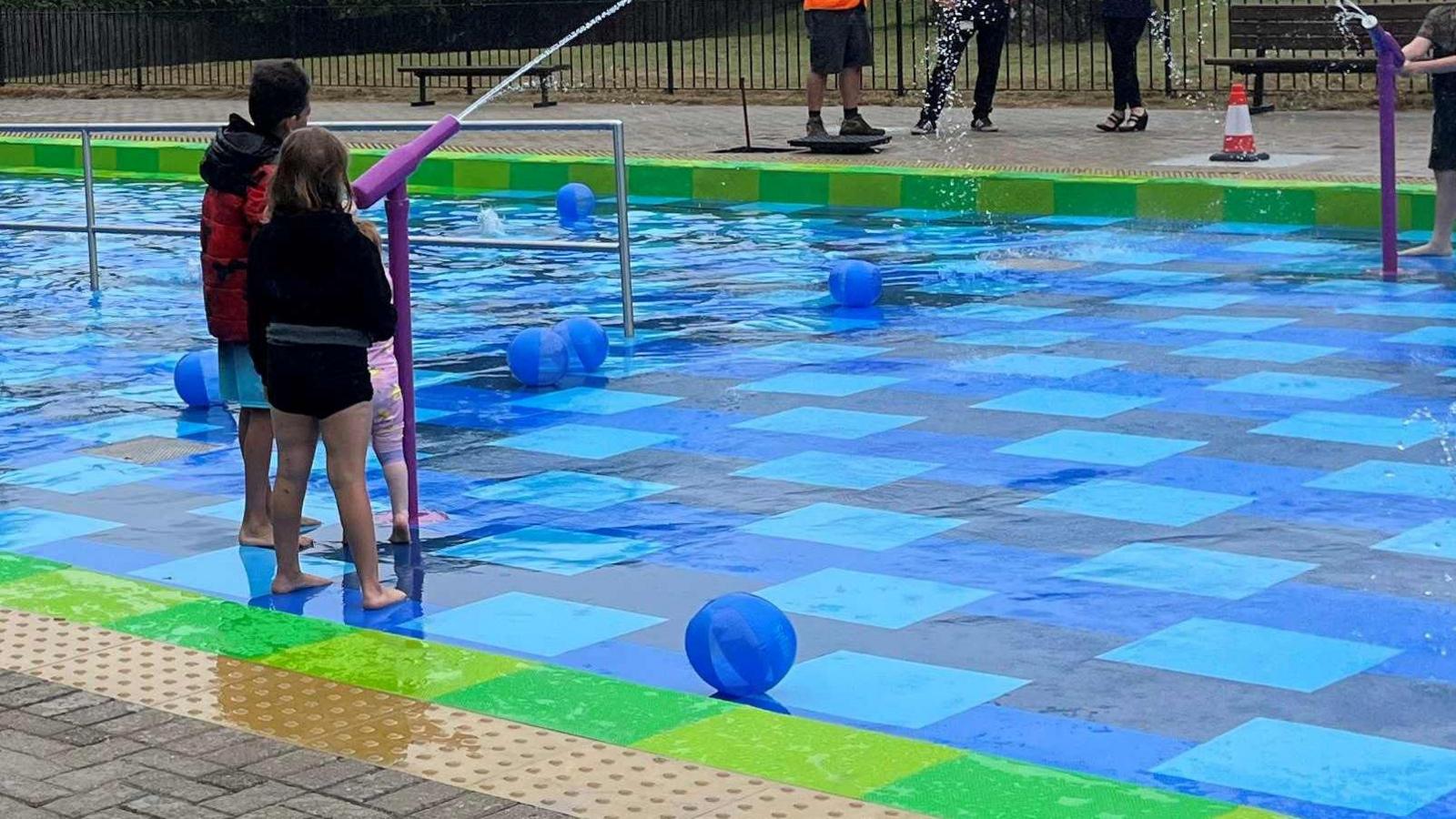 Children using water cannons 