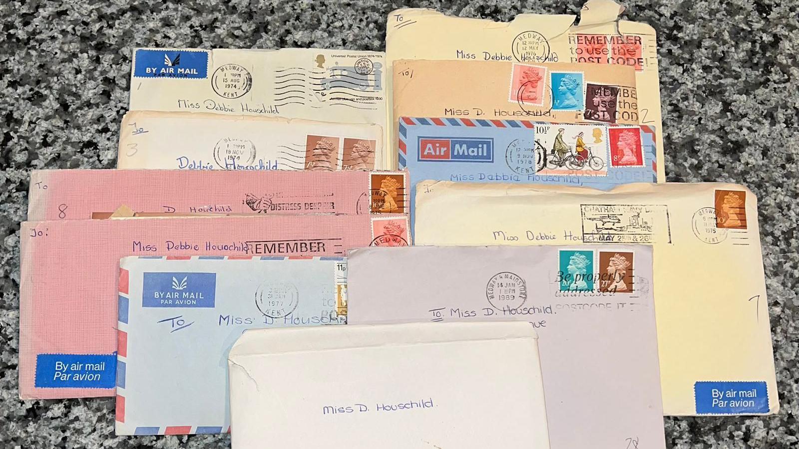 Eleven envelopes of varying colours and ages. Some have airmail markings, old stamps and postmarks. They are all addressed to Miss D Houschild.
