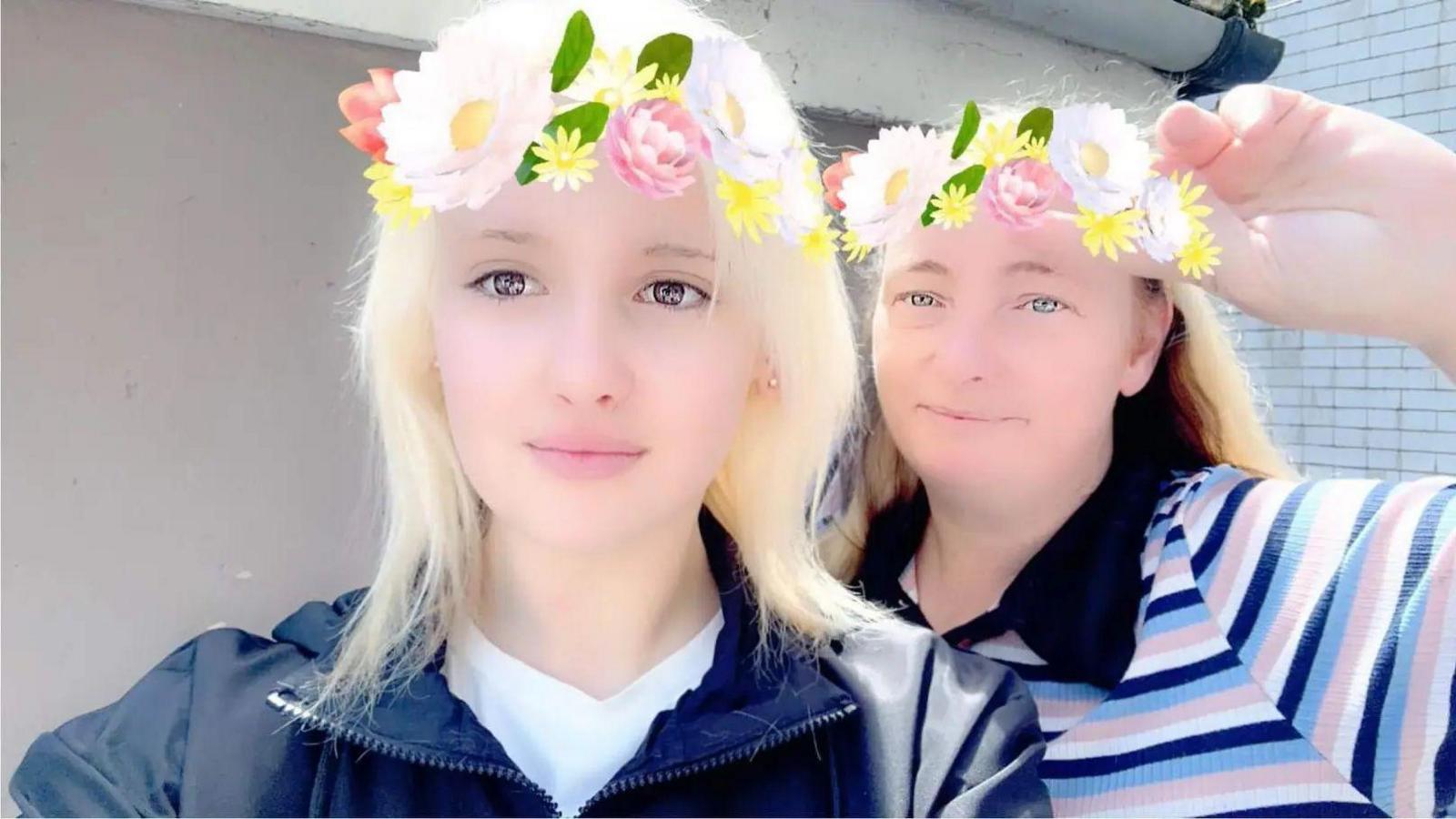 Phoebe Macias and Tamzin Abbott with a Snapchat filter on that puts a crown of flowers on their foreheads