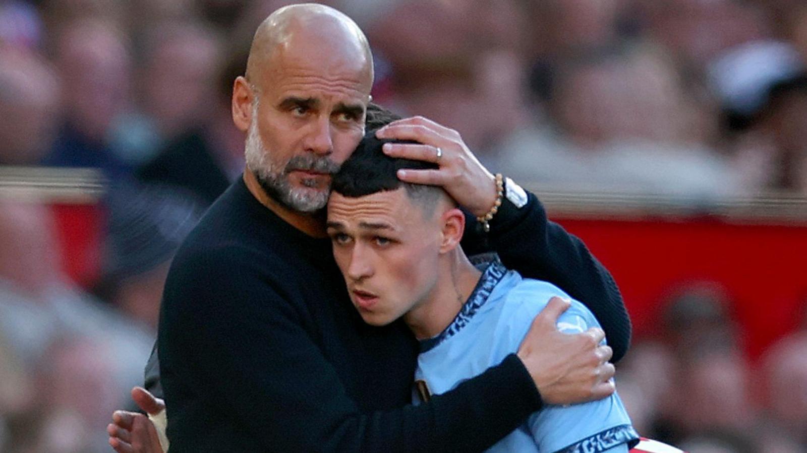 Pep Guardiola hugs Phil Foden