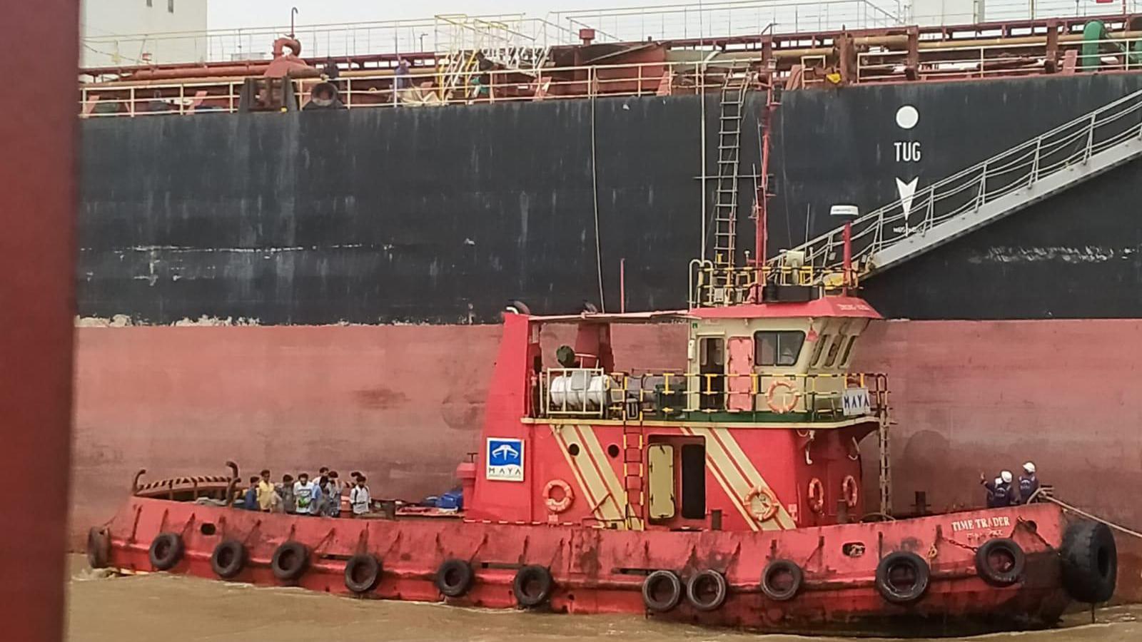 Crew members of Nirvana vessel were repatriated after months on the sea but continue to wait for their salaries. They are seen standing on a boat next to their vessel to repatriate them to the shore.