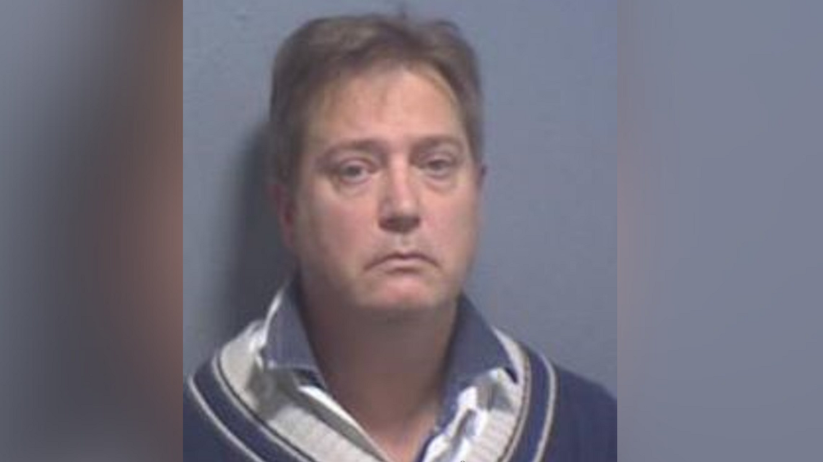 A mugshot of Gregory Manson, who has been jailed at Canterbury Crown Court. Gregory is wearing a navy jumper and shirt underneath.
