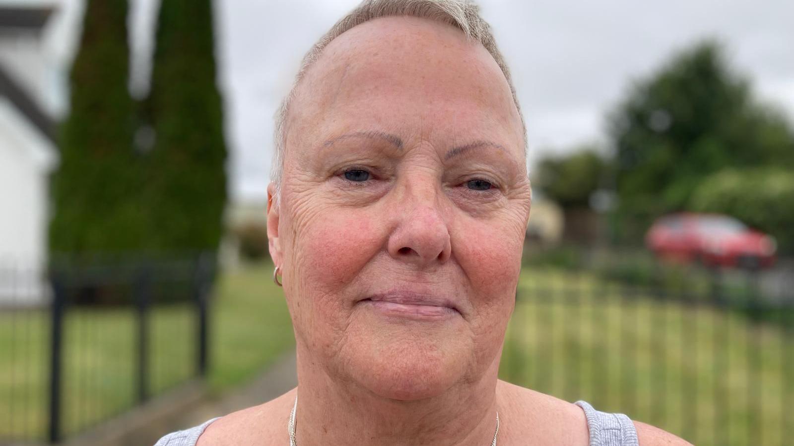 Head and shoulders picture of Barbara Owen, who has short hair and earings