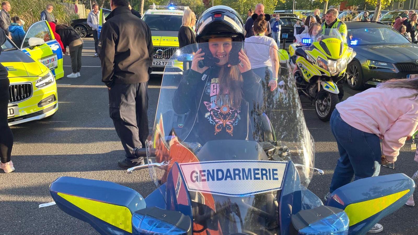 Young girl called Ava sitting on a French police motorbike