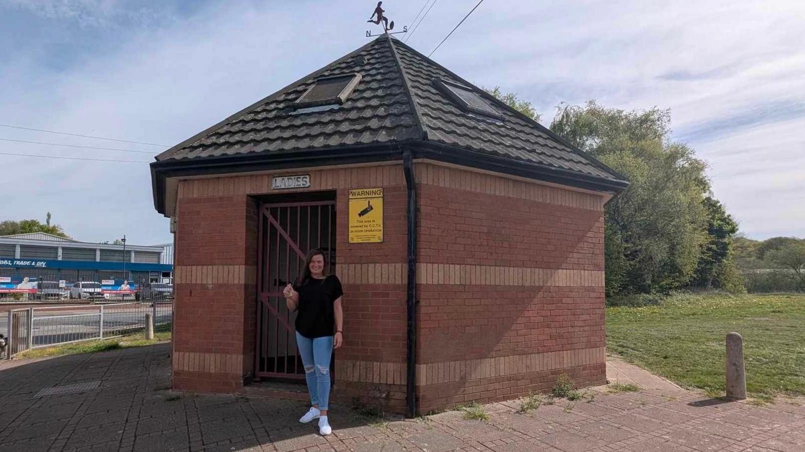 Carly Booth stood outside a toilet block in Ilkeston