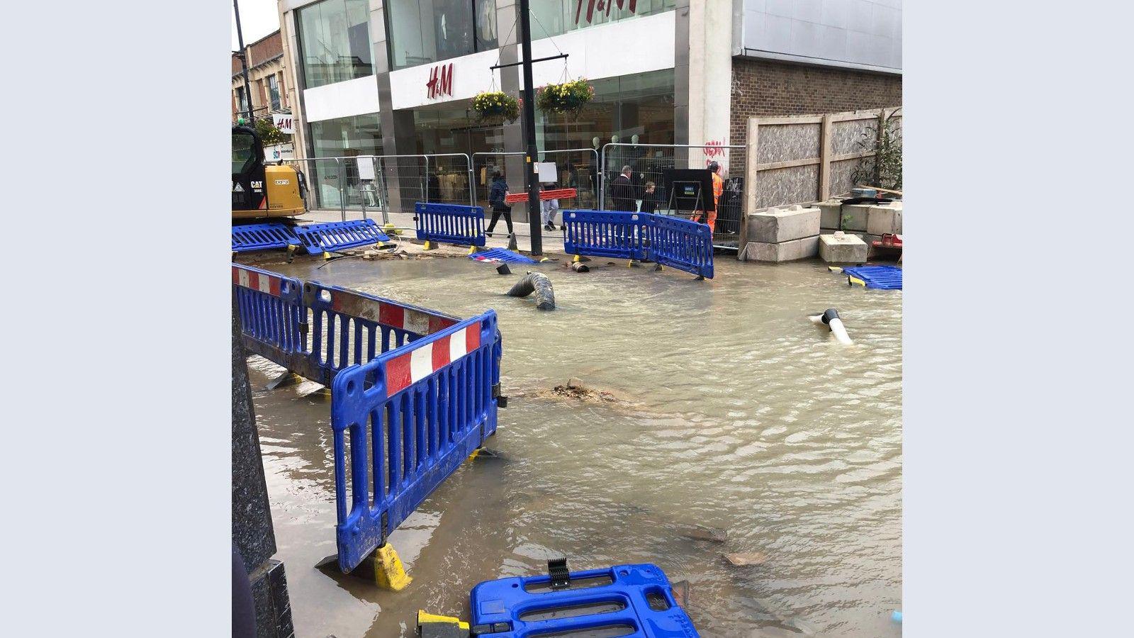 A large pool of water outside a H&M shop in Swindon town centre