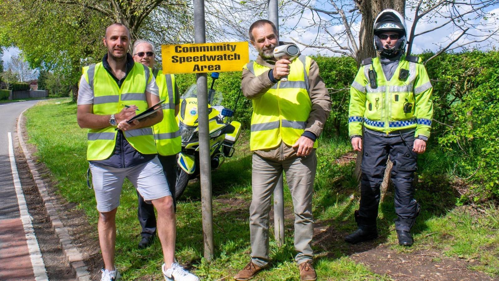 Police officers with a community speed watch group