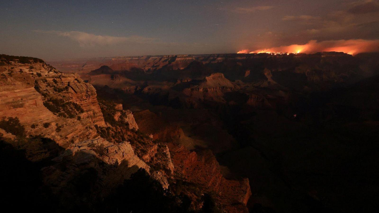 wildfire in the distance on the right hand side above lots of the grand canyon