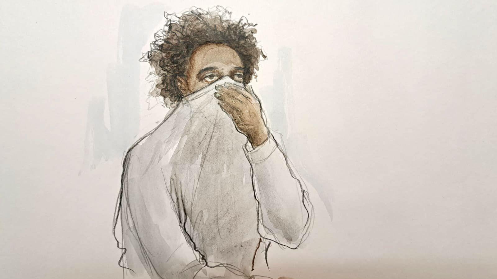 A court drawing of Axel Rudakubana in the dock holding his sweatshirt up to cover his nose and mouth.