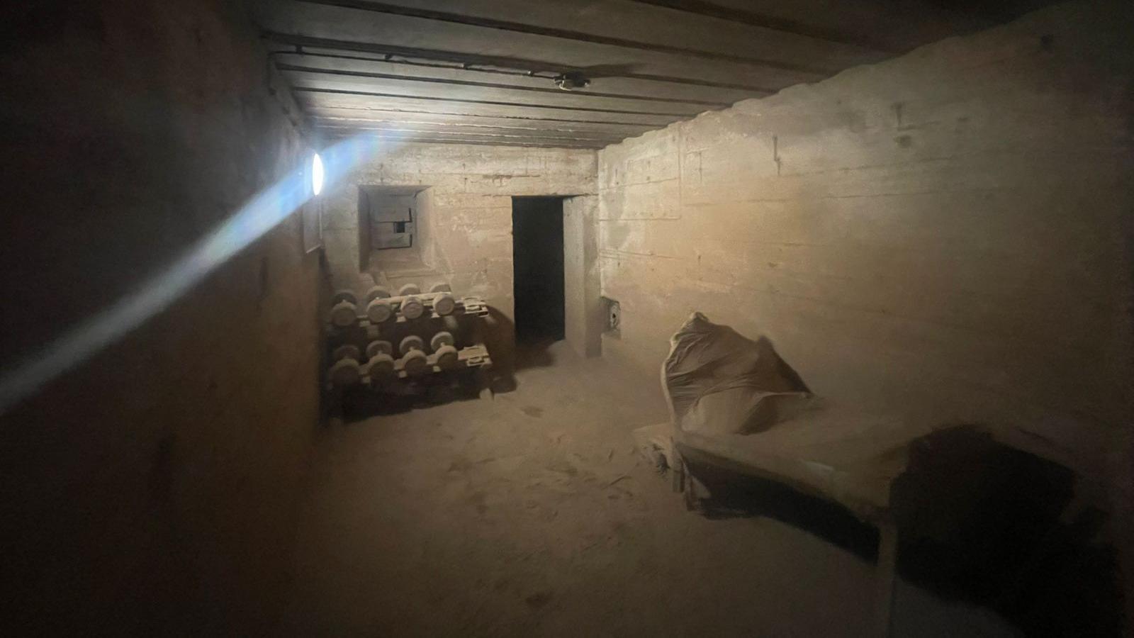 A room in a bunker which has been sand blasted during renovation work to turn it into a home gym. Sheets have been put over parts of the room.