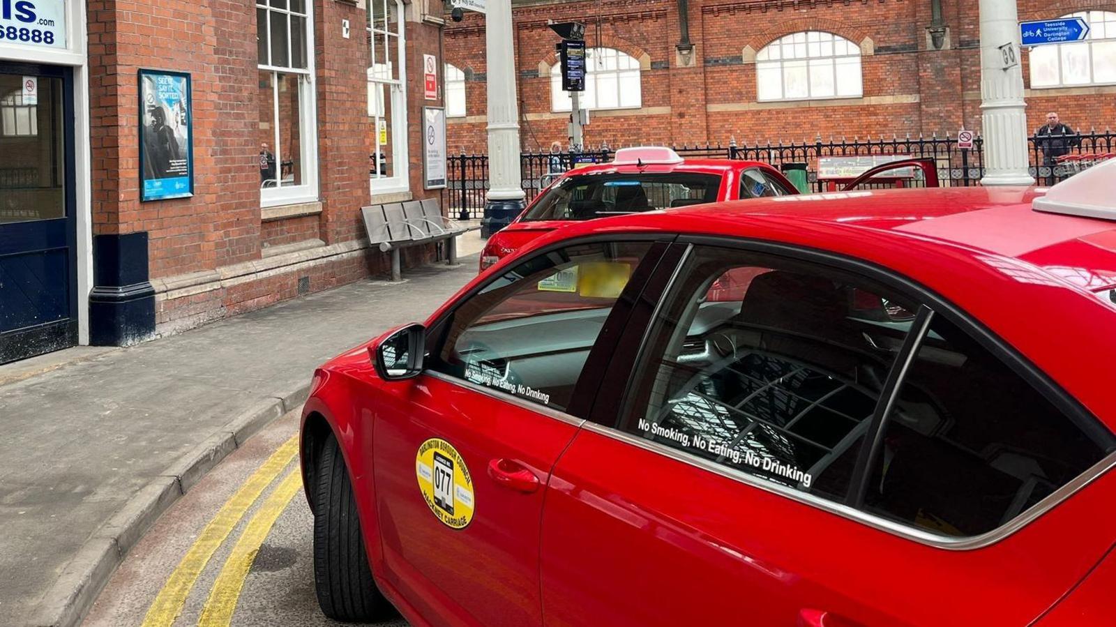 Red taxis at Darlington station