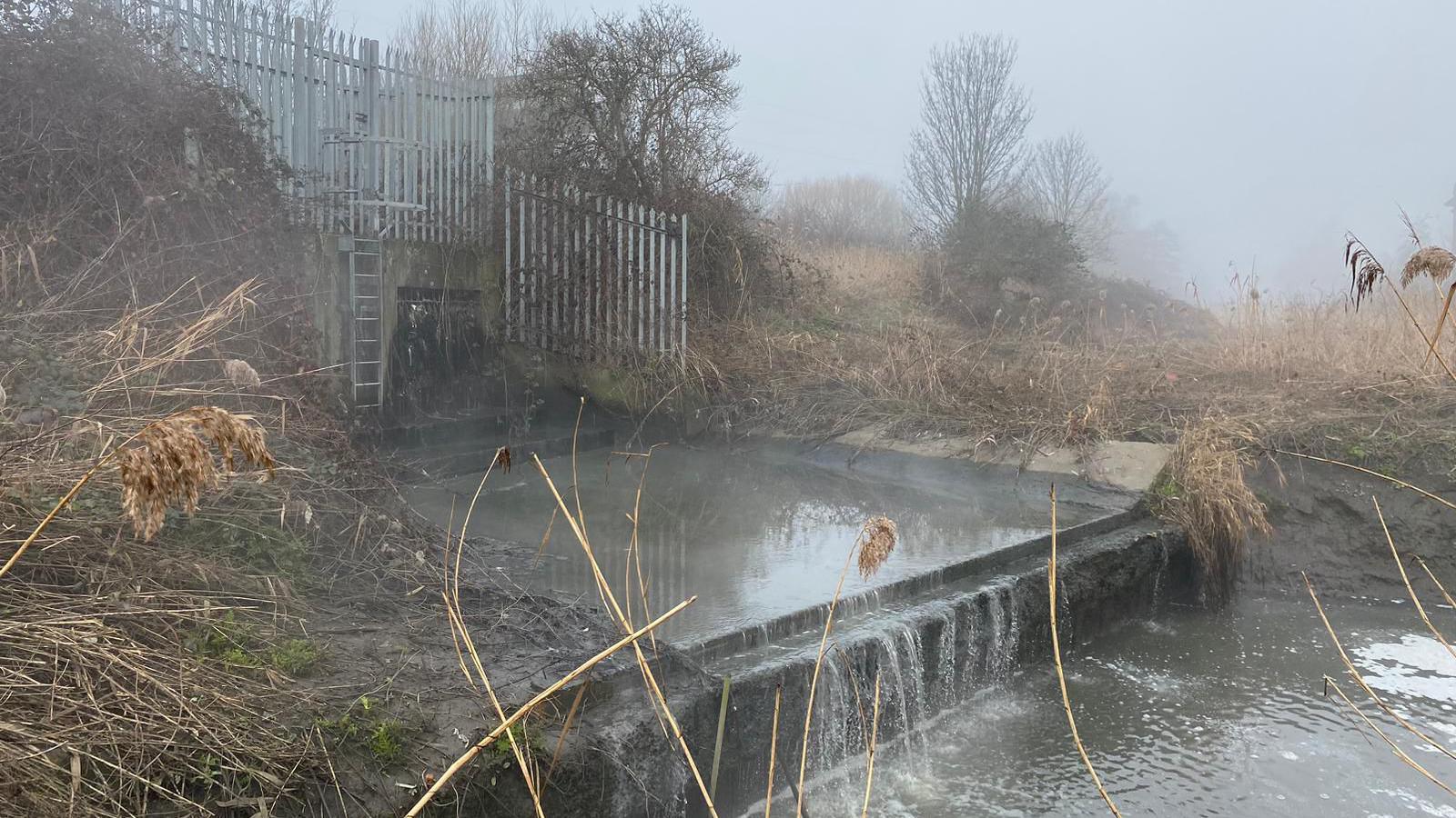 Steaming grey water coming out of an outflow pipe