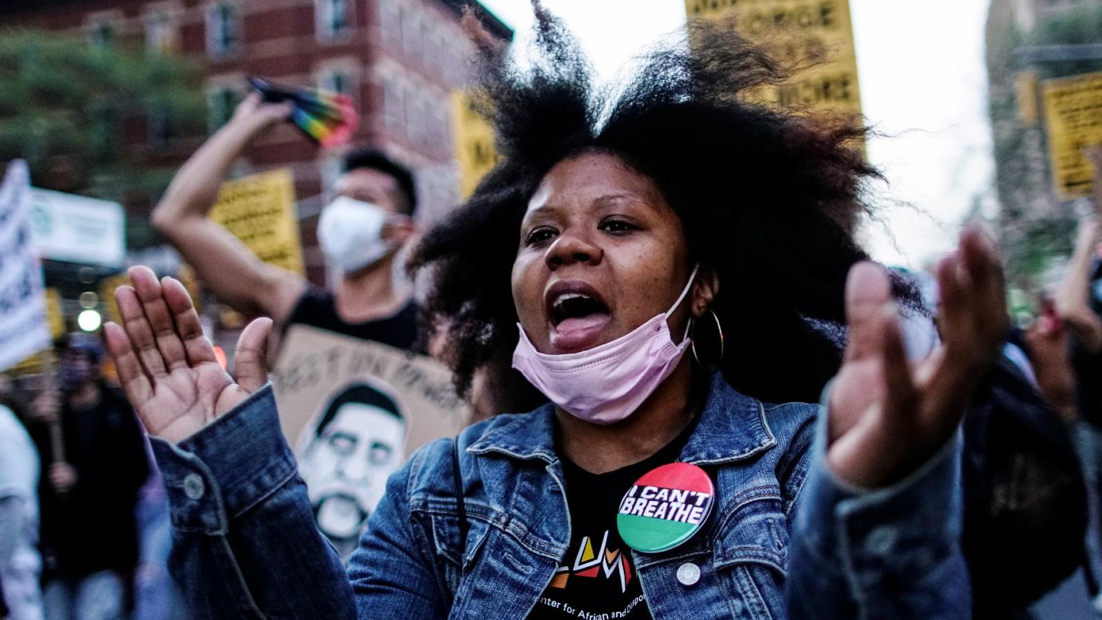 A woman reacts while marching with others after the verdict in the trial of former Minneapolis police officer Derek Chauvin, found guilty of the death of George Floyd, in New York City, New York, U.S., April 20, 2021.