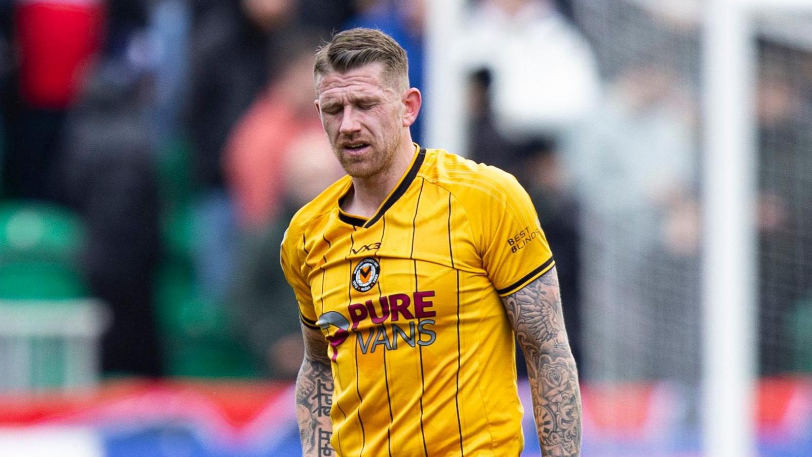 Scott Bennett winces while playing for Newport County