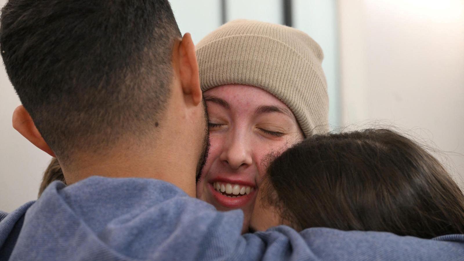 A zoomed-in crop of Naama Levy smiling as she's hugged by family members during their reunion in Israel on 30 January