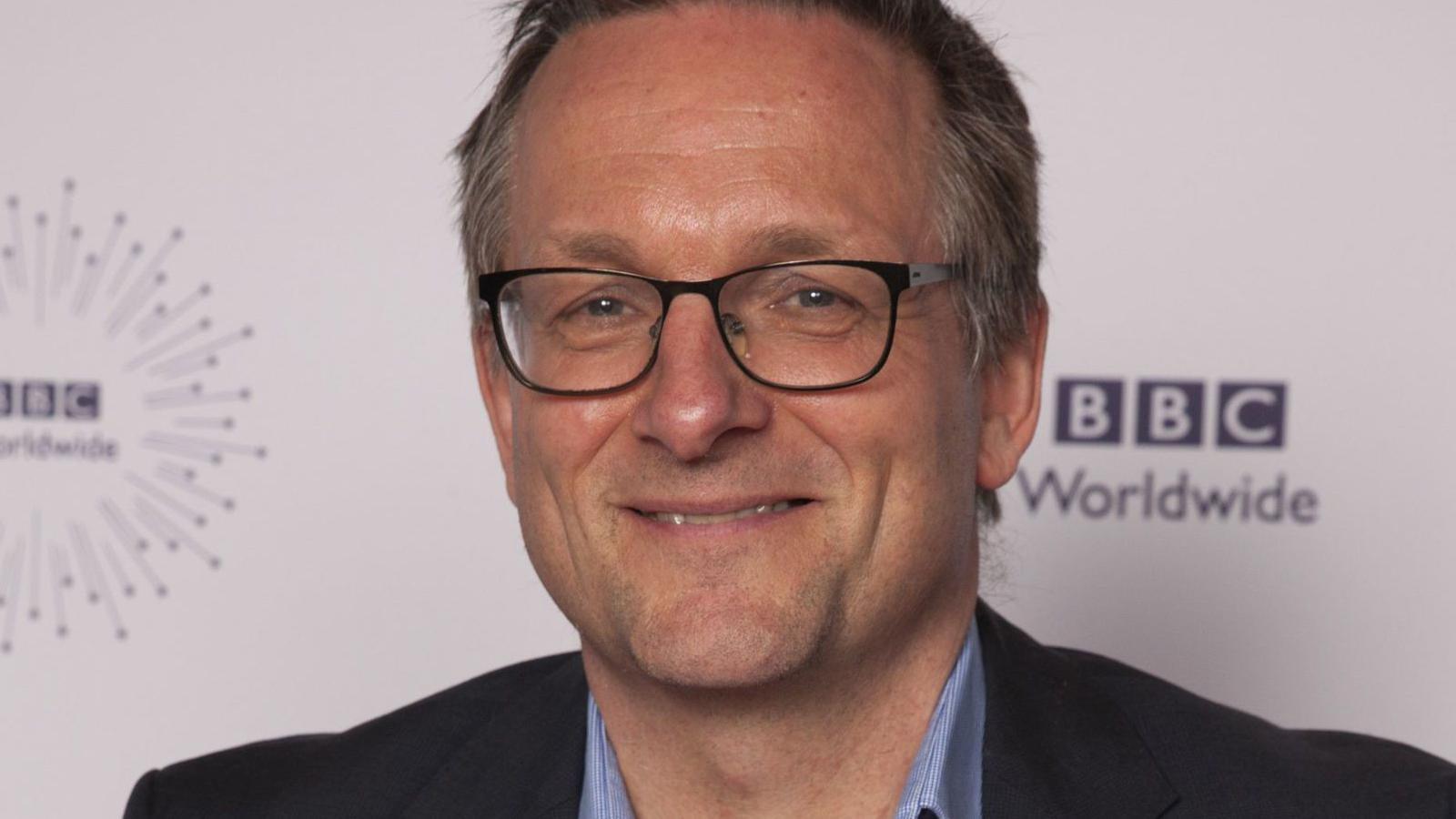 Michael Mosley smiling while wearing glasses