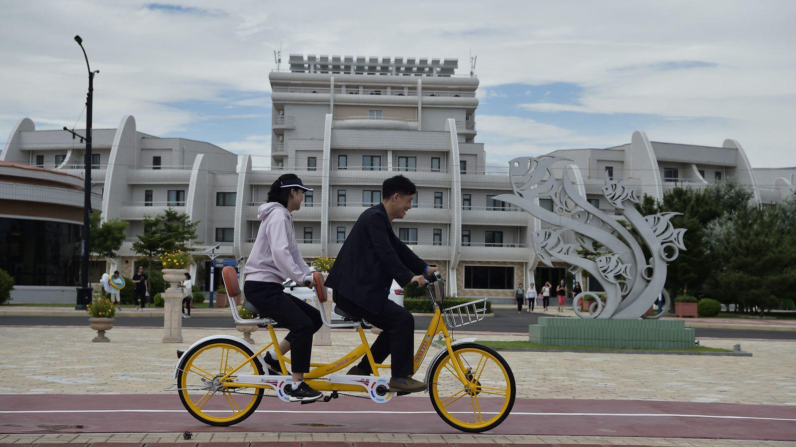 Domestic tourists ride a bicycle at Wonsan Kalma Coastal Tourist Area in Wonsan, North Korea's Kangwon Province.